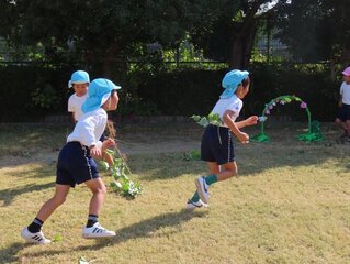 芋のツルで遊んでいる子どもたちの写真