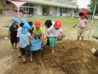 土山で遊んでいる子どもたちの写真