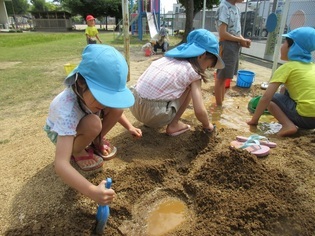 土山で遊んでいる子どもたちの写真