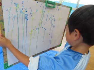 雨の絵を描いている子どもたちの写真